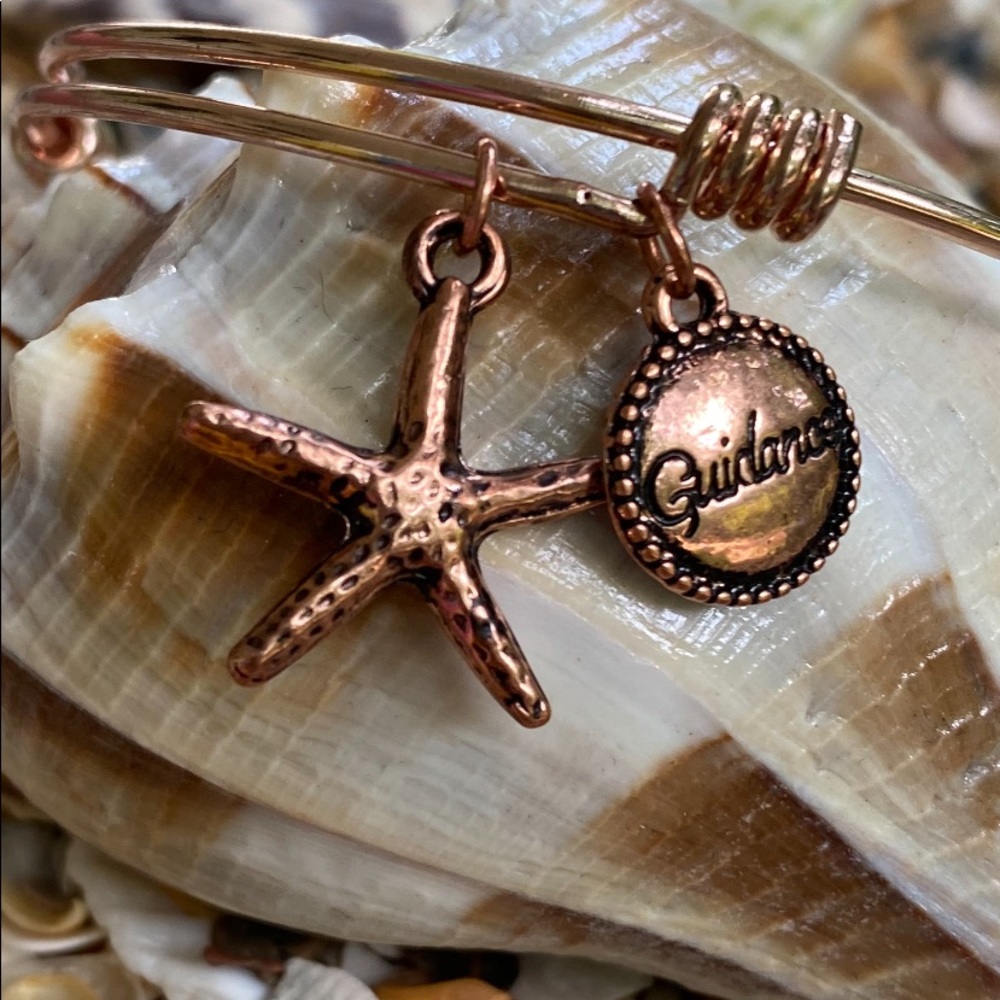 Bracelet with guidance charms. Rose gold colored